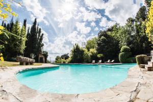 a pool with blue water in a yard at Castello Borgia in Passignano sul Trasimeno