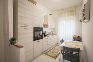 a kitchen with a table with chairs and a counter top at BarbyB B&B in Salerno