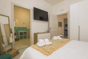 a bedroom with a large bed with a tv on the wall at BarbyB B&B in Salerno