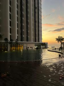 a hotel with a pool in front of a building at D'Shore Kota Kinabalu in Kota Kinabalu