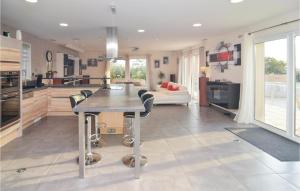 a kitchen and living room with a table and a couch at Nice Home In Saint-Gilles in Saint-Gilles +30 photos