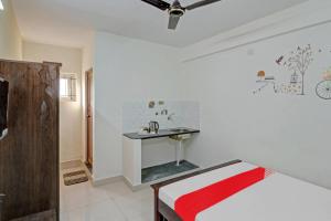 a bedroom with a bed and a sink in it at Flagship Gokul Residency in Bangalore