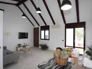 a living room with a couch and a table at Apartamento junto al mar con wifi gratuito, aire acondicionado opcional, mascotas permitidas. - ES-184-56 in Riumar