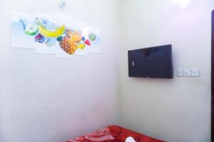 a corner of a room with a tv and a bed at Hotel Green Garden Residential Jatrabari in Dhaka