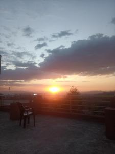 a sunset with a chair in front of a fence at Zan-Seyoum Hotel - Lalibela in Lalībela