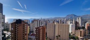 a view of a city with tall buildings and mountains at VISTAMAR 33 in Benidorm +23 photos