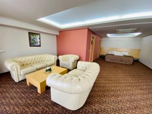 a hotel room with two couches and a bed at Hotel Zenica in Zenica
