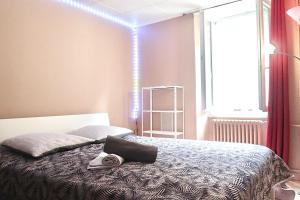 a bedroom with a bed with a bag on it at City Garni in Martigny-Ville