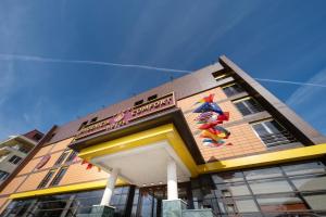 a building with a mural on the side of it at Phoenicia Comfort Hotel in Bucharest
