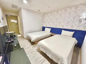 Postel nebo postele na pokoji v ubytování Walker Hotel - Zhengyi