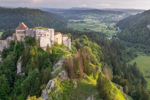 a castle on top of a mountain with trees at Appartement au pied des pistes in Les Fourgs