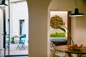 a dining room with a table and a room with a couch at Casa S a f e r in Florence