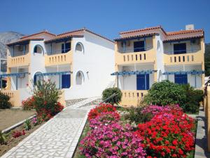 a building with flowers in front of it at Pavlis Studios Kampos in Marathokampos