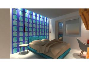 a bedroom with a bed and a blue wall at B&B Maiori Suites - New opening in June 2024 in Maiori