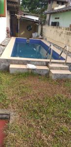 a swimming pool with stairs next to a house at Kuchi Villa in Kalutara