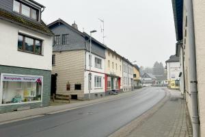 an empty street in a town with buildings at Work&Stay Apartments Hellenthal in Hellenthal
