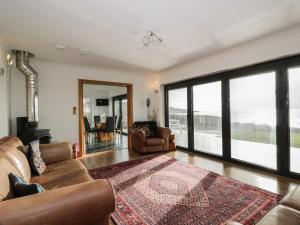 a living room with two couches and a rug at Merse End in Dalbeattie