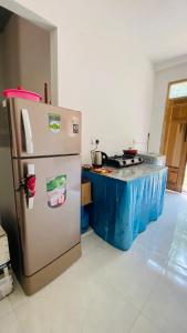 a kitchen with a stainless steel refrigerator and a counter at Elisha Place Hiriketiya in Dickwella