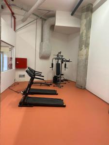 a gym with two tread machines and an orange floor at StudentVille Central in Lisbon