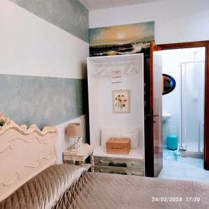 a bedroom with a bed and a bathroom with a mirror at Casa Patrizia B&B cir in info in Sirmione
