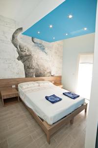 a bedroom with a bed with a blue ceiling at Mary Lucy in Porto Cesareo