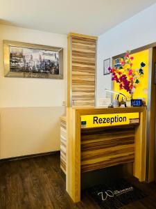 a room with a reception desk with flowers on it at B&S Hotel Am Bachhaus in Eisenach