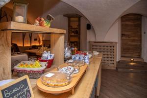 a kitchen with a counter with food on it at Hotel Gran Trun in Sauze dʼOulx