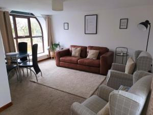 a living room with a couch and a table at Celtic Minor Cottage in Ystalyfera