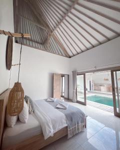 a bedroom with a large bed and a pool at Mimpi Villa - Gili Air in Gili Air +18 photos