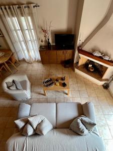 a living room with a couch and a fireplace at Homey Stoupa, Mani in Stoupa +18 photos