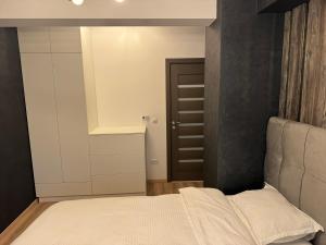 una piccola camera con letto e parete nera di Casa de la Luna Apartment a Iaşi