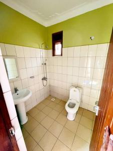 a bathroom with a toilet and a sink at Agabet Hotel - Mbale in Mbale