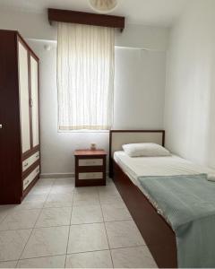 a small bedroom with two beds and a window at Atalay Apart Otel in Bodrum City +13 photos