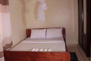 a small bed in a room with at Agabet Hotel - Mbale in Mbale