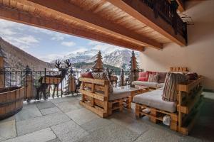 a living room with a view of the mountains at Residence Larice Bianco App n3 in Campodolcino