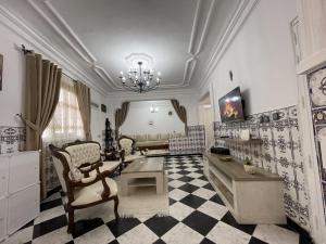 a large living room with a chandelier and a couch at Casa Marwan in Tétouan