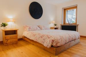 a bedroom with a large bed and a window at Alloggio in antica frazione Walser in Alagna Valsesia