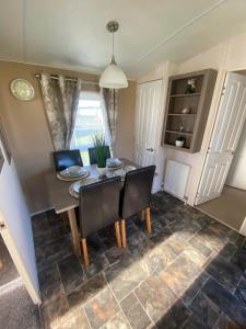 a dining room with a table and chairs at Impeccable 2-Bed Lodge in Ashington in Ashington