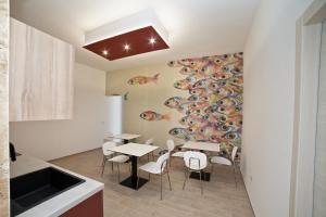 a kitchen and dining room with a table and chairs at Mary Lucy in Porto Cesareo