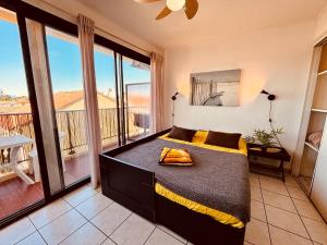 a bedroom with a large bed with a balcony at Studio moderne à la plage in Canet-en-Roussillon