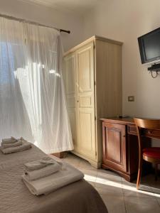 sypialnia z łóżkiem, biurkiem i telewizorem w obiekcie Mamamia #Lipari w mieście Lipari +33 zdjęcia