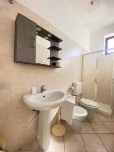 a bathroom with a sink and a toilet and a mirror at Mamamia Lipari in Lipari