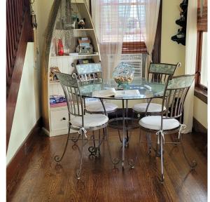 a dining room with a glass table and chairs at Ethyl's Place in Port Clinton