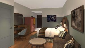 Habitación de hotel con cama, mesa y sofá en Hotel Nickel Plate Fishers, Tapestry Collection By Hilton, en Fishers