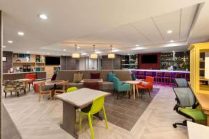 a restaurant with colorful chairs and tables and a bar at Hawthorn Extended Stay by Wyndham Kingwood Houston in Kingwood