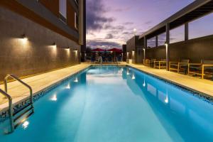 a swimming pool with blue water in a building at Hawthorn Extended Stay by Wyndham Kingwood Houston in Kingwood