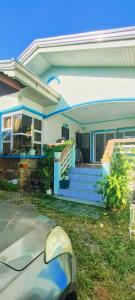 a house with a car parked in front of it at Puerto Galera Transient Guest Room in Puerto Galera