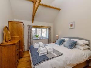 a bedroom with a large bed with towels on it at Budding in Dyrham