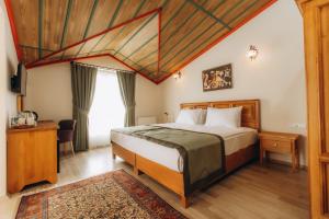 a hotel room with a bed and a window at Cappadocia Villa Comfort in Nevşehir