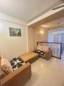 ブリンダーバンにあるZenRoofs - Brij Bhumi Haven 2のベッド2台とソファのあるリビングルーム